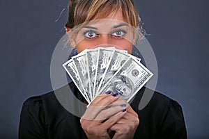 Girl with stack of dollar bills