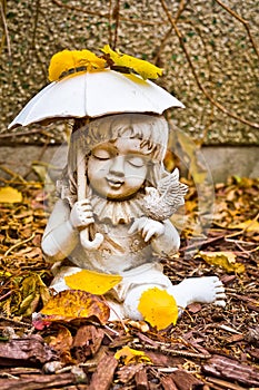 Young Girl Holding Umbrella and Bird Statue