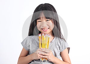 Young girl holding yellow pencils