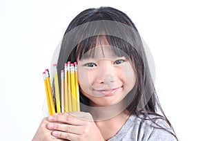 Young girl holding yellow pencils