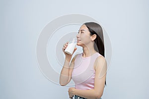 young girl holds glass of milk