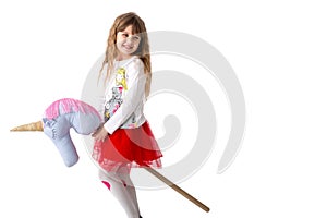 Young girl holds a toy ridge between the legs on a white background. Isolated