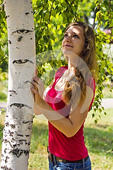 Young girl hugged birch