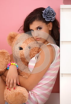 Young girl hugging toy bear