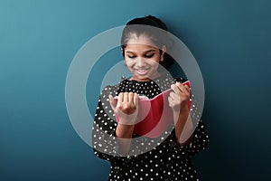 Young girl of Indian origin with a tablet phone