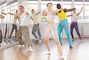 Young girl and international dancers preparing their modern dance performance at dance studio