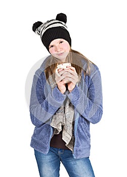 Young girl with jacket and wooly hat holding cup