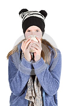 Young girl with jacket and wooly hat holding cup photo