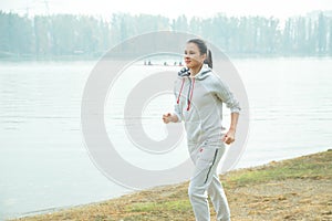 Young girl jogging outside in the park