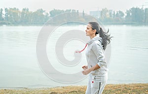 Young girl jogging outside in the park