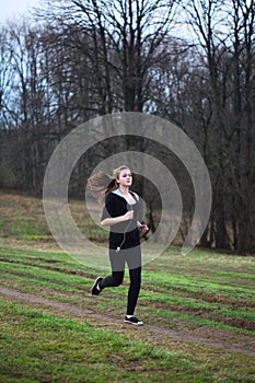 A young girl jogging in a park