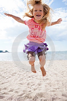 Young girl jumping at beach