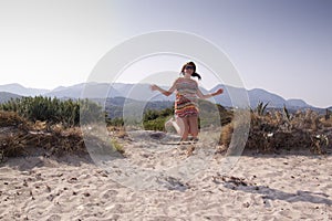 Young girl jumping on the beach