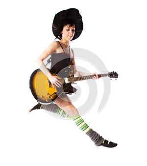 Young girl jumping with a guitar