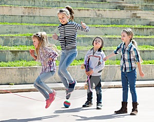 Young girl jumping while jump rope game