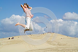 Young girl jumping in sky