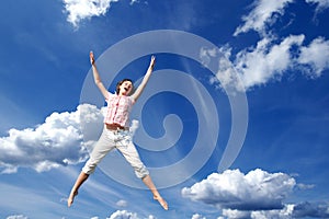 Young girl jumping in sky