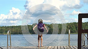 Young girl jumping into water