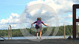 Young girl jumping into water