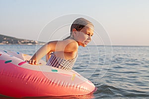 Young girl kid child eight years old splashing in sea having fun leisure activity open arms