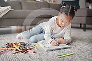 Young girl, kid and pencils on floor with coloring book in living room for education, learning or creative development