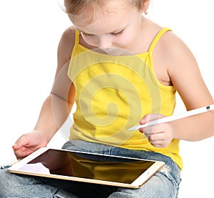 Young girl kid sitting reading learning drawing on digital tablet touch screen pad with pencil