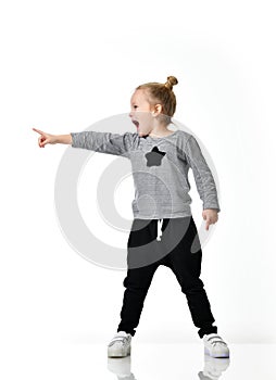 Young girl kid surprised yelling shouting pointing finger at the corner