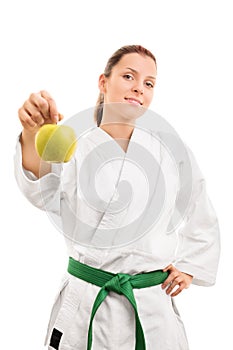 Young girl in kimono holding an apple