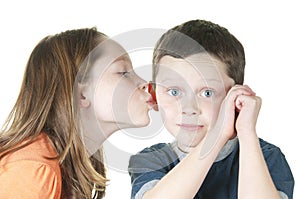 Young girl kissing boy on cheek photo