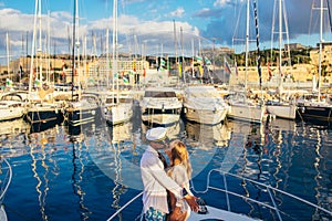 Young girl kissing with her boyfriend on yacht