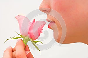 Young girl kissing rose
