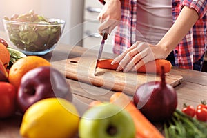 Young girl at kitchen healthy lifestyle standing cutting ingredients for salad close-up