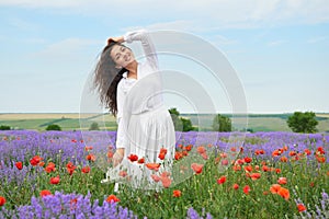 Young girl is in the lavender field, beautiful summer landscape with flowers