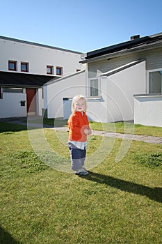 Young girl on lawn in garden