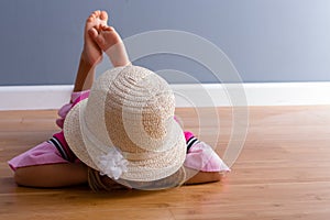 Young girl laying on the floor face down