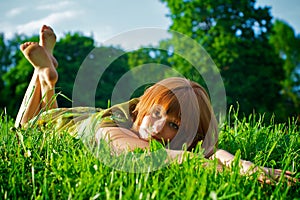 Young girl laying in grass