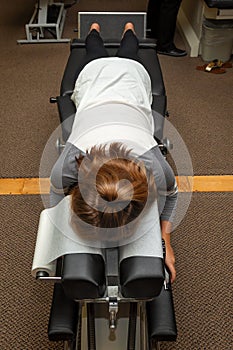 Young Girl Lays Face Down on a Chiropractic Adjustment Table