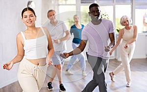 Young girl learning modern dynamic dances during group class