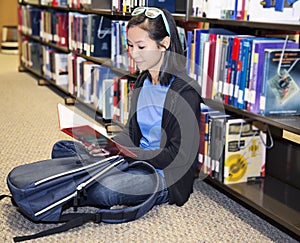 Young girl library reading book