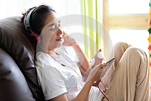 Young girl listen to music from headphone