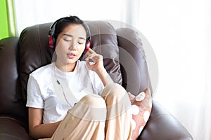 Young girl listen to music from headphone