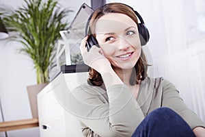 Young girl listen to music with headphones