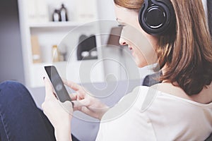 Young girl listen to music with headphones