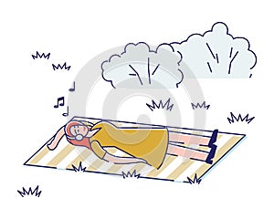 Young girl listen to music lying on blanket in park. Woman enjoy music with closed eyes outdoors