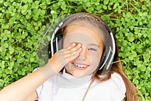 Young girl listening music with professional DJ headphones