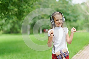 Young girl listening music with professional DJ headphones