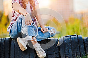 young girl listening to music on headphones, urban street style, outdoor street style hipster woman