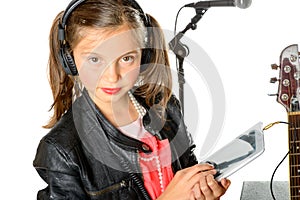 A young girl listening to music on his digital tablet