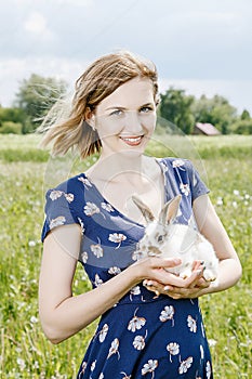 Young girl with a little rabbit. photo