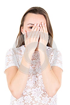 Young girl with long hair covers his face with his hands